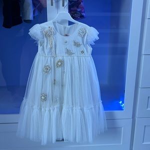 Flower girl dress. White with little white and gold accessories.